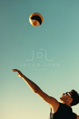 Beach volleyball player in action during championship game with arms raised on coastal beach